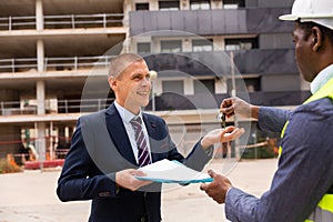 Happy businessman gets the keys to new shopping center