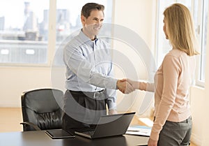 Happy Businessman Greeting Candidate In Office