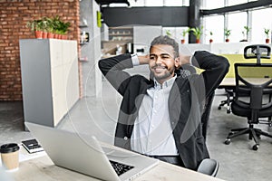 Happy businessman having fun at work. Young smiling professional men resting during the working day at office.