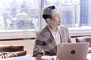 Happy businessman having meeting to success deal business at skyscraper office with cityscape business zone background