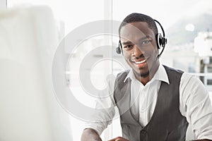 Happy businessman with headset interacting