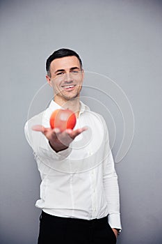Happy businessman holding apple
