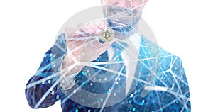 Happy businessman holding bitcoin coin in decentralized network photo