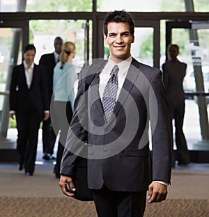 Happy businessman holding briefcase