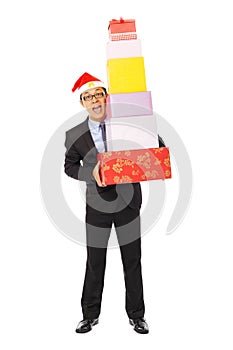 Happy businessman holding gift boxes . isolated on white