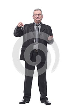 Happy businessman holding the keys and looking at camera