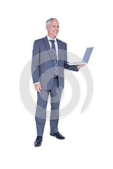 Happy businessman holding laptop computer