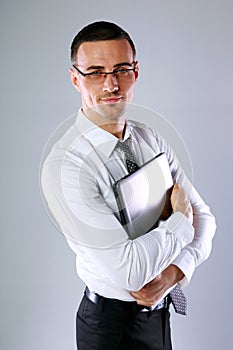 Happy businessman holding laptop