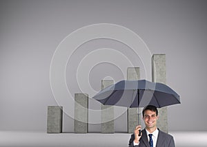 Happy businessman holding umbrella