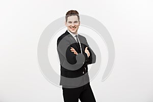 Happy businessman isolated - Successful handsome man standing with crossed arms isolated over white background.