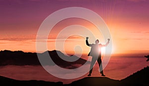 Happy Businessman Jumping On The Top of Mountain Sunset .Successful Man Jumps for Joy with Beautiful Landscape Background.