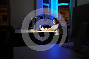 Happy businessman with laptop after successful presentation or video conference call with partner