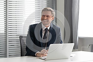 Happy businessman laughing, listening to joke, having fun at office.