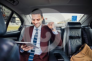 Happy businessman in limo car