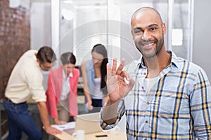 Happy businessman making okay gesture