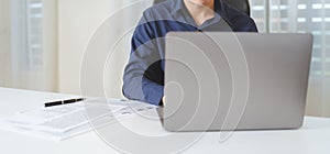 Happy businessman, male businessperson using computer laptop with paperwork on desk at office. Professional entrepreneur business