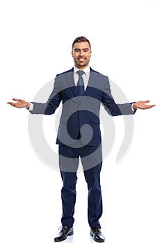 happy businessman in navy blue suit opening arms and smiling