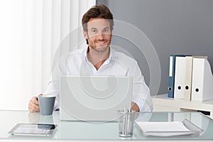 Happy businessman in office