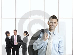 Happy businessman in office lobby