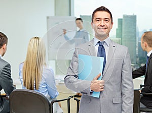 Happy businessman with open folder