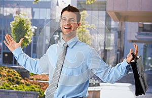 Happy businessman outside office