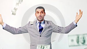 Happy businessman with packets of dollar money