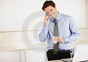 Happy businessman, phone call and laptop with coffee for discussion or communication in kitchen at home. Man or employee