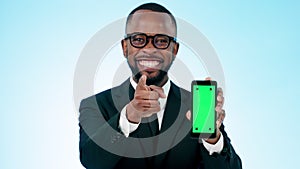 Happy businessman, phone and pointing with green screen in advertising against a studio background. Portrait of black