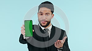 Happy businessman, phone and pointing to green screen in advertising against a studio background. Portrait of man or