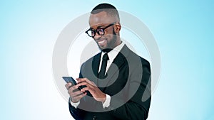 Happy businessman, phone and typing in social media, communication or networking against a studio background. Black man