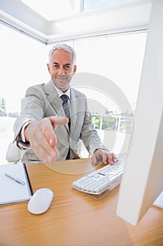 Happy businessman reaching hand out for handshake