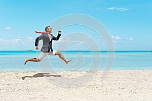 Happy businessman running away from office work on the beach. Summer vacation concept