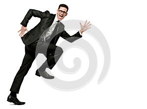 Happy businessman runs in black suit on white.