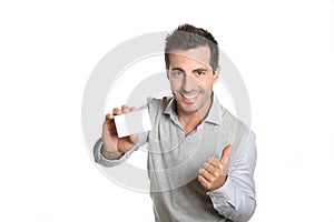 Happy businessman showing a blank card