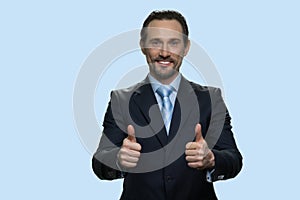 Happy businessman showing two thumbs up.