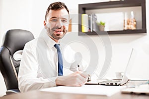 Happy businessman signing some documents