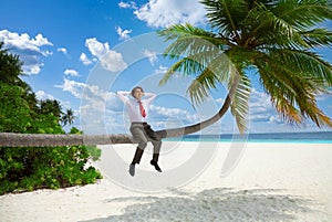 Happy businessman sitting on the palm and relax