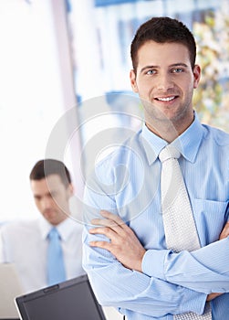 Happy businessman smiling in office