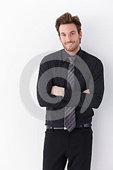 Happy businessman standing arms crossed