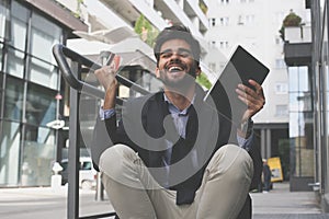 Businessman on street using credit card and iPod and rece photo