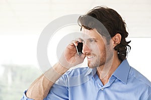 Happy businessman talking on cell phone