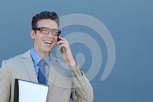 Happy businessman talking on the phone with folder in hand over blue background in studio shooting