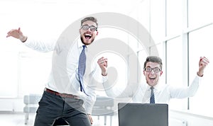 Happy businessman throwing business documents up