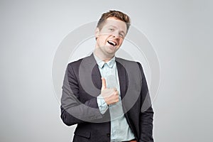 Happy businessman thumbs up sign on white background