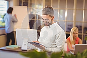 Happy businessman using digital PC