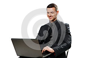 Happy businessman using laptop