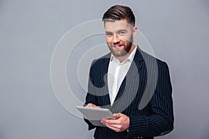 Happy businessman using tablet computer