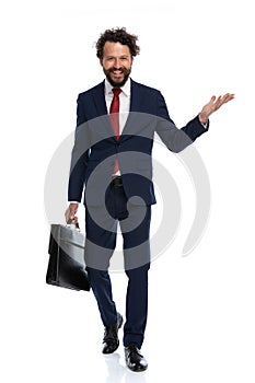 Happy businessman walking towards the camera with an open arm