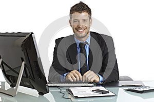 Happy businessman working at desk