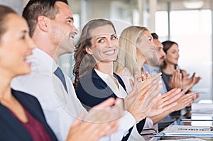 Happy businesspeople applauding at conference